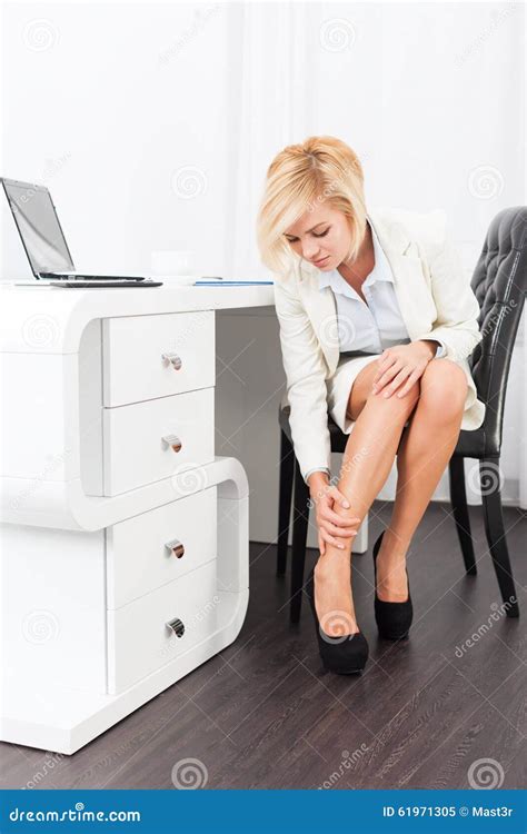 legs of business woman sitting in suit with shoes royalty free stock image