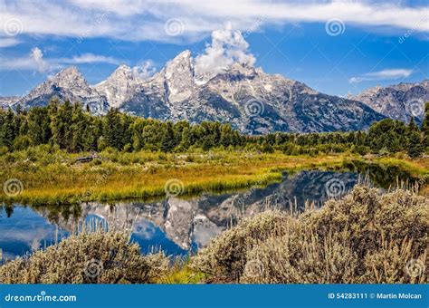 Scenic View Of Grand Teton Mountains With Water Reflection Stock Image