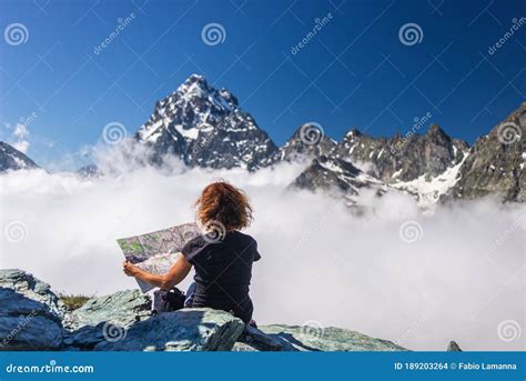Woman On High Mountain Top Looking At Map View Dramatic Landscape