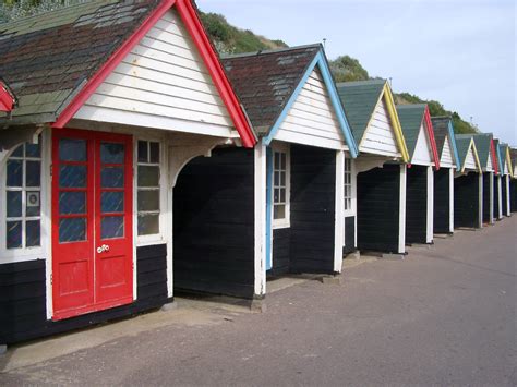 Free Stock Photo Of Wooden Beach Huts Aligned Along The Seashore