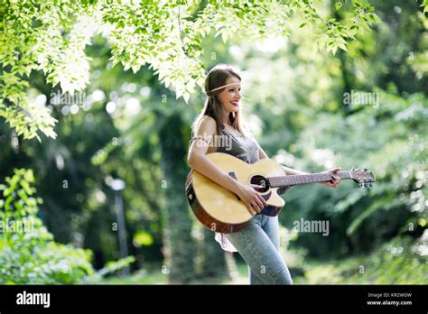 Beautiful Woman Playing Guitar In Nature Stock Photo Alamy