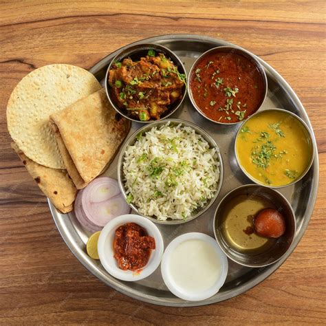 premium photo veg thali from an indian cuisine food platter consists variety of veggiespaneer