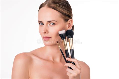 Gorgeous Young Woman Holding Makeup Brushes Isolated On White Stock