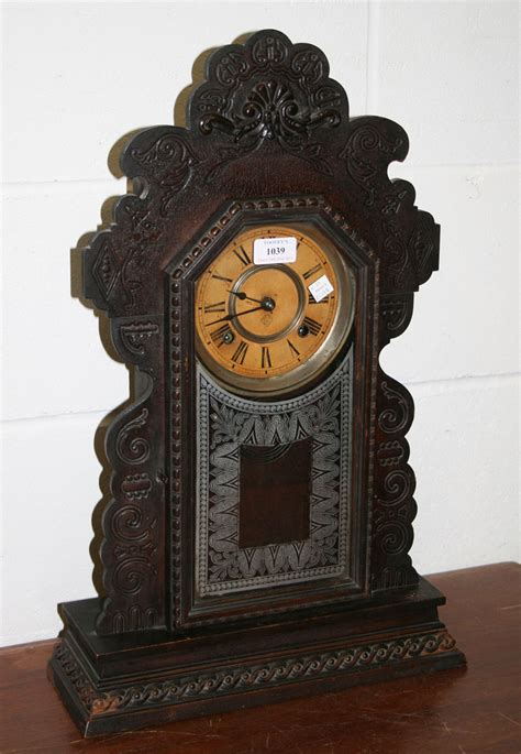 A Late 19th Century American Mantel Clock With Eight Day Movement Striking On A Bell Together With