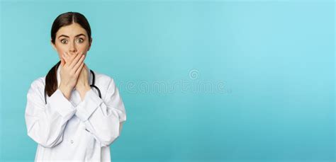 Shocked And Concerned Woman Doctor Clinic Worker Covering Mouth With