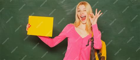Premium Photo Excited Amazed Teacher Student Girl Holding Empty Faper