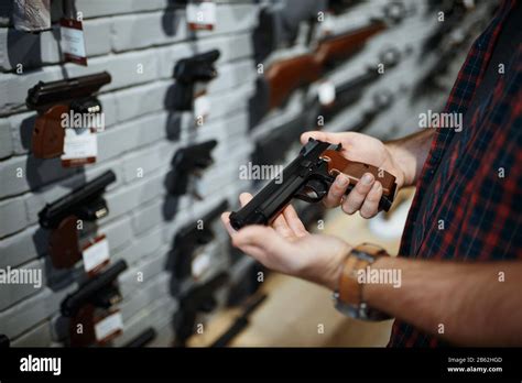 Man Holds Handgun In Gun Shop Stock Photo Alamy