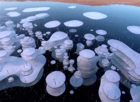 Beauty Of Frozen Methane Bubbles On The Worlds Deepest Lake Shown In