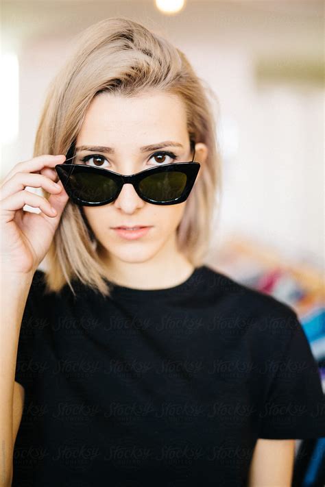 Portrait Of Beautiful Blonde Woman Looking At Camera Over Sunglasses By