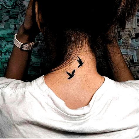 To Flying Birds Tattoo Inked On The Back Of The Neck