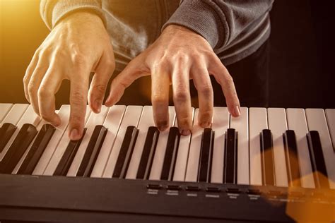 Mans Hand Playing Piano Hear And Play Music Learning Center
