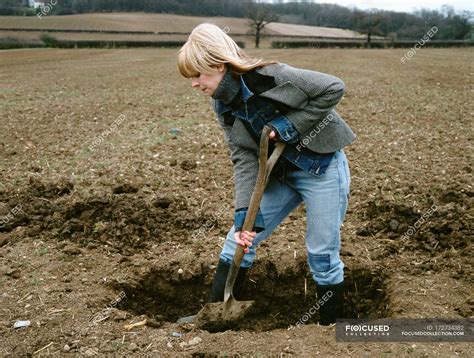Farmer Digging Hole In Field — Beautiful Female Stock Photo 172734382