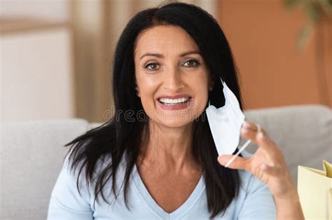 portrait of mature woman taking off medical face mask stock image image of person home 203523819