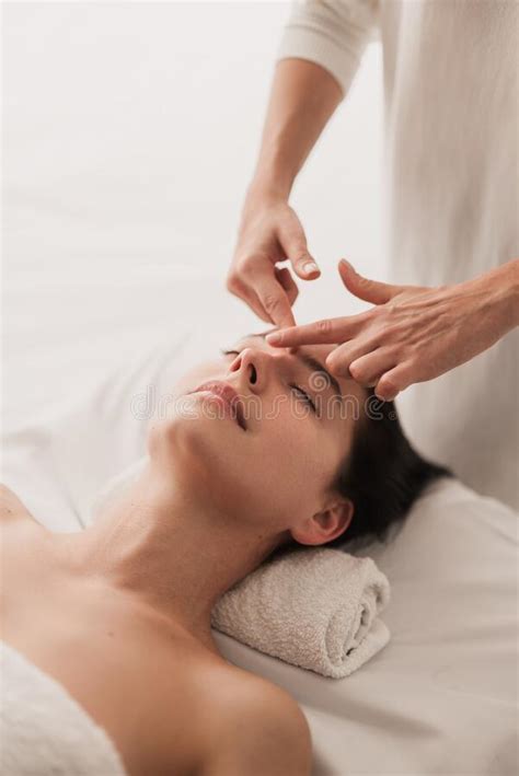 Crop Therapist Doing Facial Massage To Relaxed Female Client In Salon Stock Image Image Of