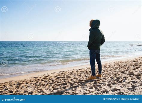 Man Standing On The Beach And Looking At The Sea Stock Photo Image Of