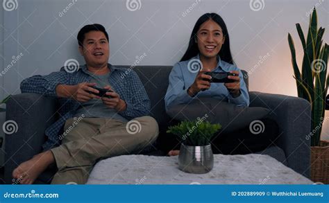 Asian Couples Are Having Fun Playing Games In Their Living Room At Night Stock Image Image Of