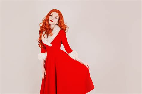 Slim Redhead Woman In Red Christmas Dress On White Background Santa