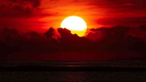 Download Wallpaper 1366x768 Sunset Sea Sun Clouds Dusk Tablet
