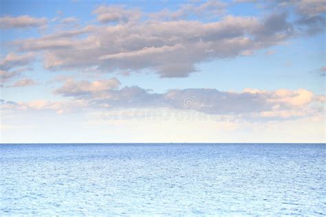 Cloudy Blue Sky Leaving For Horizon Blue Surface Sea Stock Photo