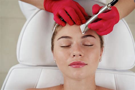 Cosmetologist Making Hardware Cleaning Of The Face Of Beautiful Young