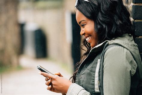 African American Girl Using Mobile Phone By Stocksy Contributor Aila