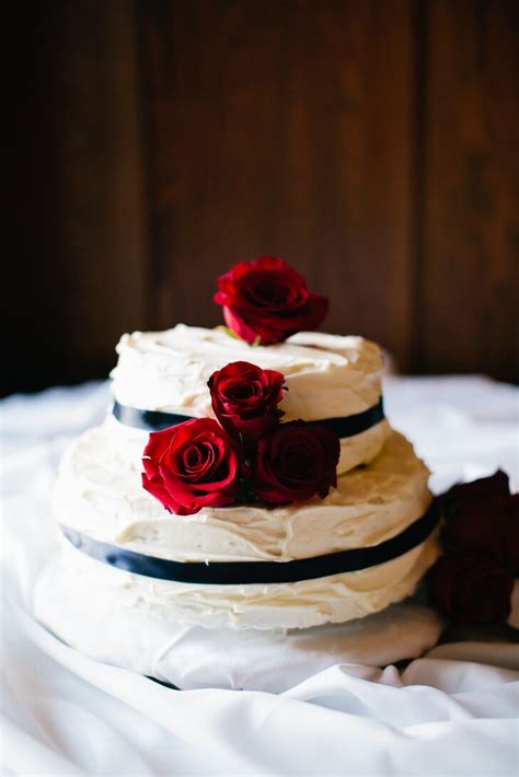 Vanilla, milk chocolate, mocha, coffee, . Buttercream Wedding Cake with Red Roses and Black Ribbon