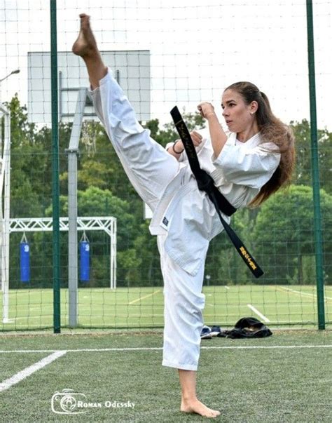 A Woman Is Doing Karate On The Grass