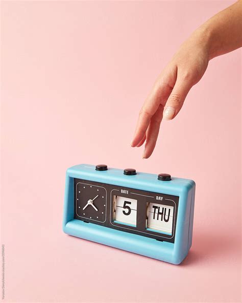 Womans Hand Presses On The Button On Retro Clock By Stocksy