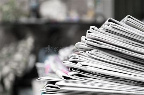 Newspapers Folded And Stacked On The Table Dark Background Image