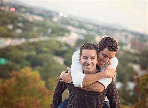 Two Men Hugging Each Other On Top Of A Hill