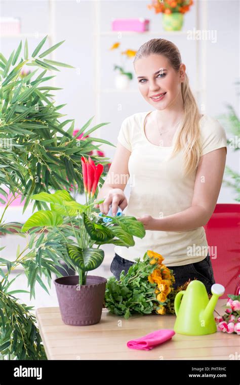 Young Woman Watering Plants In Her Garden Stock Photo Alamy