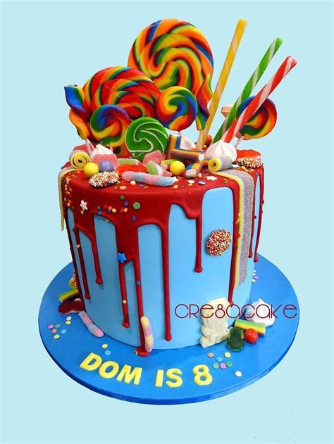 A Birthday Cake Decorated With Candy And Lollipops