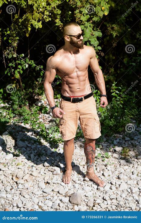 Portrait Of Muscular Man Standing Outdoors In Nature Stock Image