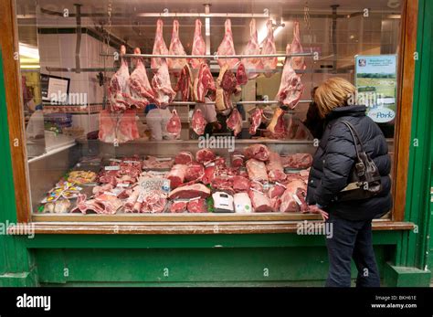 Meat Hangs On Display In A Traditional Butchers Shop Window With A