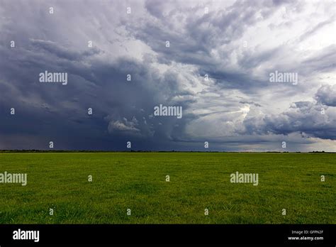 Supercell Storm Clouds Above Meadow With Green Grass Summer Storm