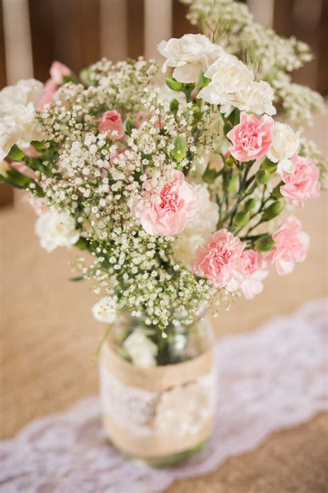 A Romantic Mix Of Pink Carnations And Baby S Breath Were Displayed In
