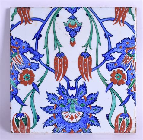 An Artistic Tile With Blue And Red Flowers On The Outside Against A