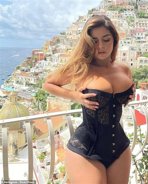 Demi Rose Flaunts Her Very Ample Cleavage In A Racy Black Corset As She