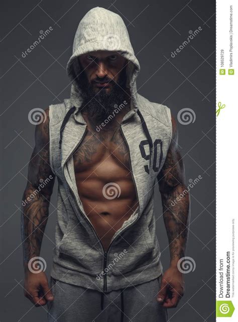 Brutal Muscular Tattooed Gay In Grey Sports Costume Stock Image