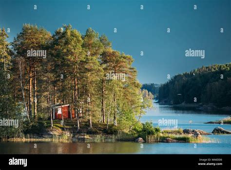 Sweden Beautiful Red Swedish Wooden Log Cabin House On Rocky Island