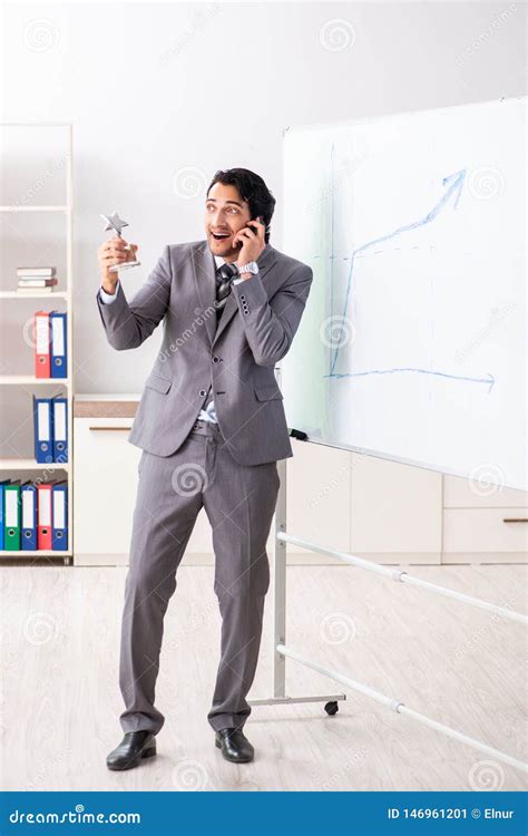 The Young Handsome Businessman In Front Of Whiteboard Stock Image