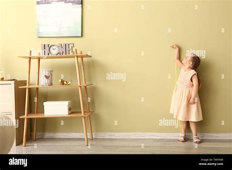Little Girl Measuring Height Near Wall Stock Photo Alamy