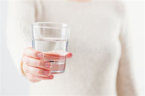 A Woman Holds A Glass Of Water In Her Hands Stock Image Image Of