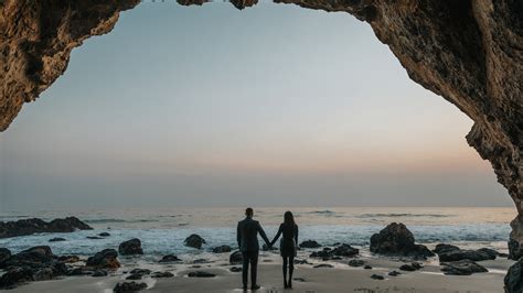 Couple Holding Hands Ocean Background Stones Seashore Hd Couple