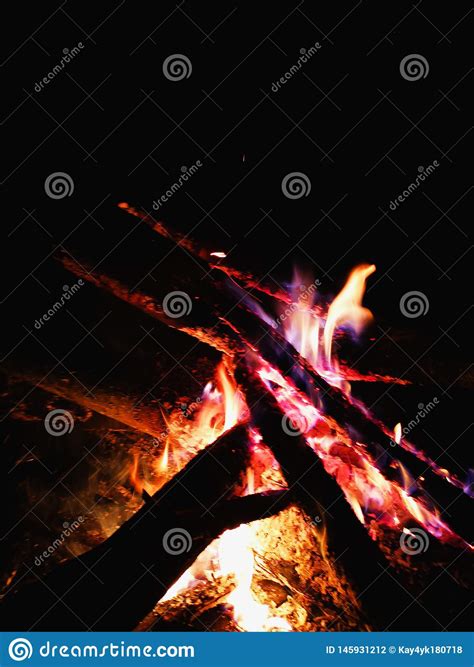 Extreme Close Up Of Fire Sparks Moving On Dark Night Sky As Black