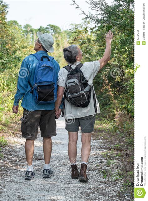 Mature Couple Holding Hands And Hiking On Nature T Royalty