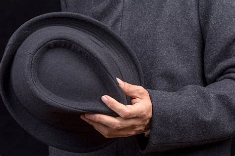 Hand Holding A Black Fedora Hat Stock Photos Pictures And Royalty Free