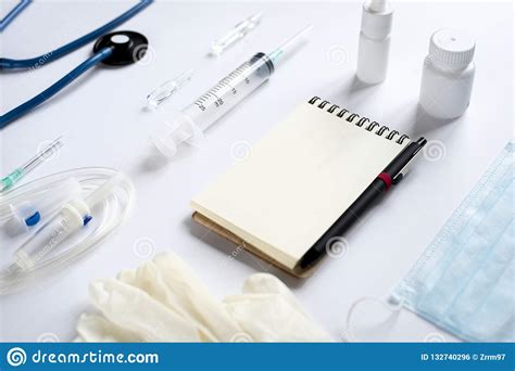 Various Medical Equipment And Notepad On White Background Stock Photo