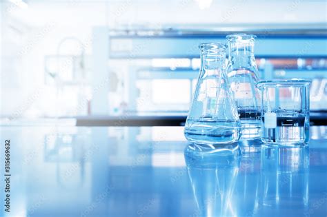 Water In Beaker And Flask Glass In Chemistry Blue Science Laboratory