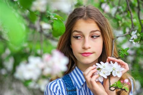 Premium Photo Pretty Teen Girl Are Posing In Garden Near Blossom Tree